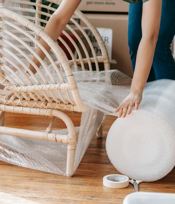Person moving gracefully in a minimalist space with violet light.